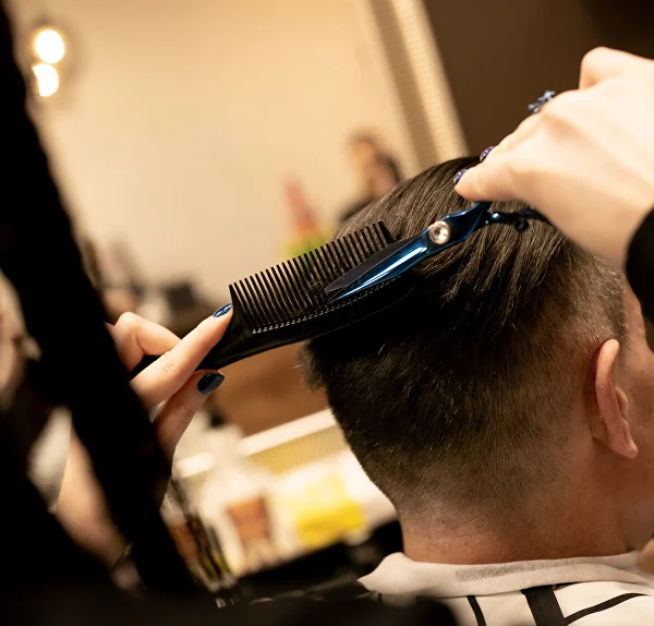 Men’s haircut with scissors and a comb