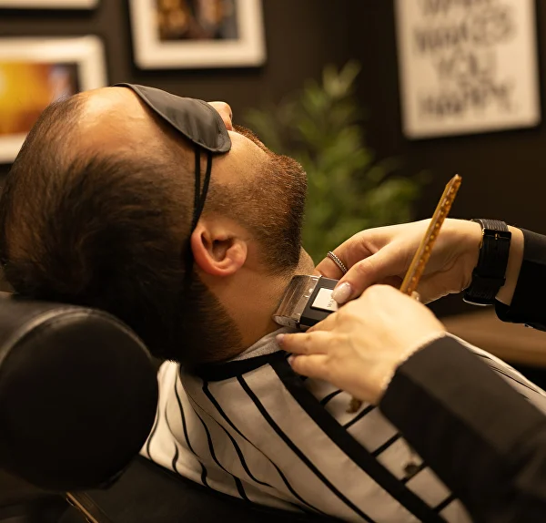 Shaping the beard neckline with a razor